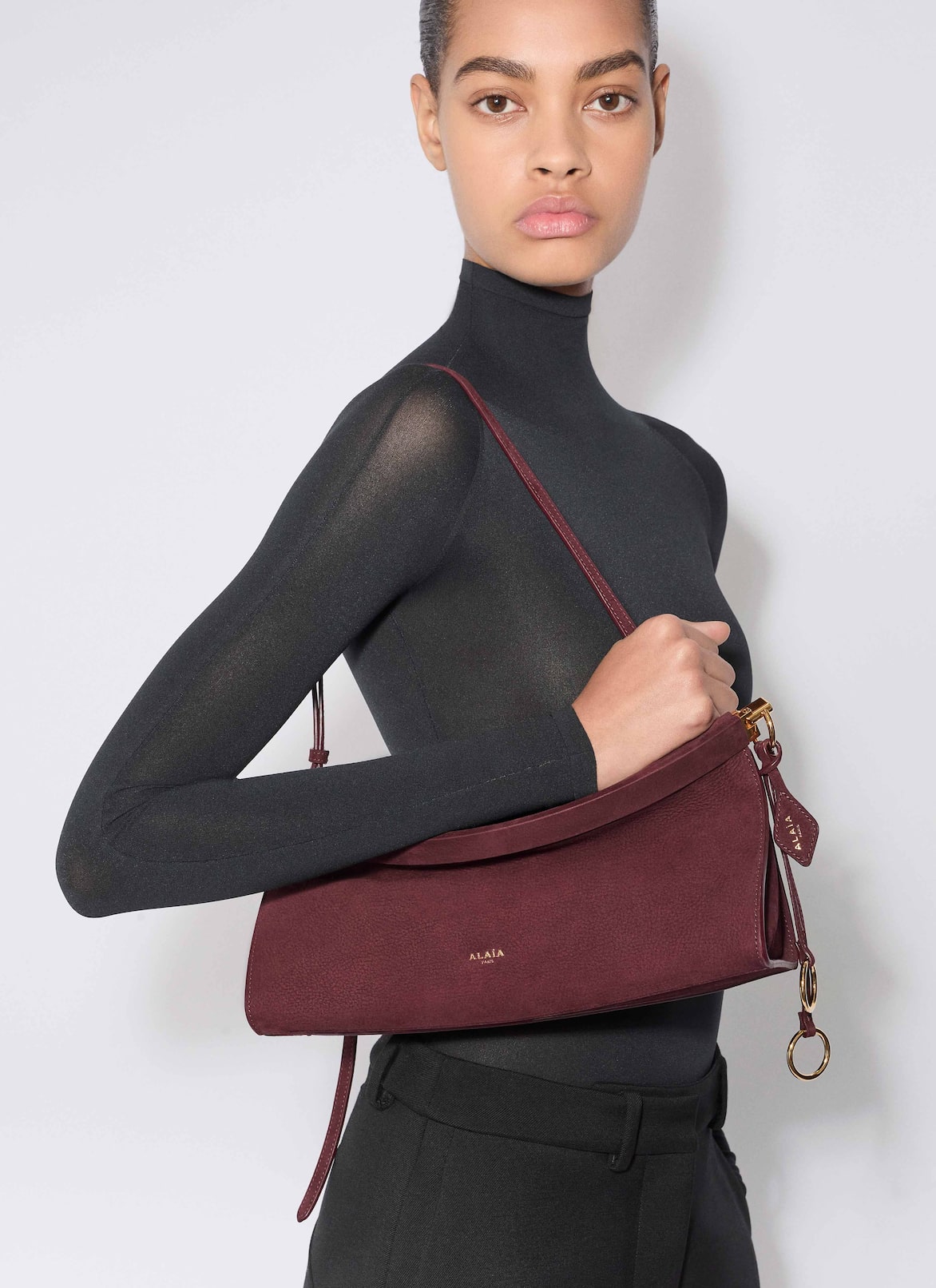 LE CLICK EAST WEST MEDIUM BAG IN NUBUCK ALAÏA GARNET RED LE CLICK EAST WEST MEDIUM BAG IN NUBUCK